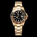 GMT dorado — Esfera negra y bisel negro y marrón